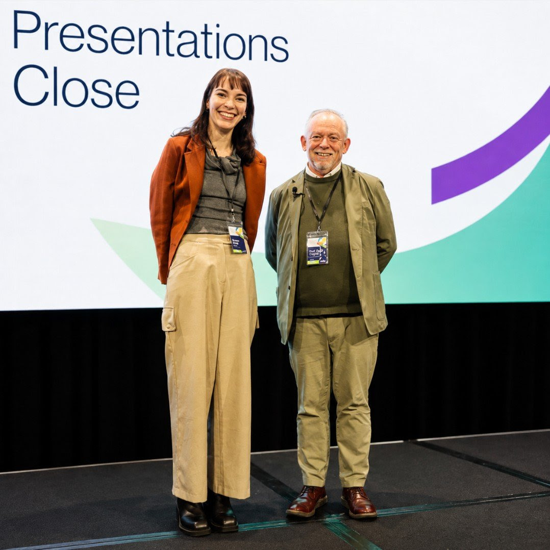 Eleanor Beilby on stage at the AADPA 9th Annual Conference after receiving the 2026 Best Oral Presentation Award